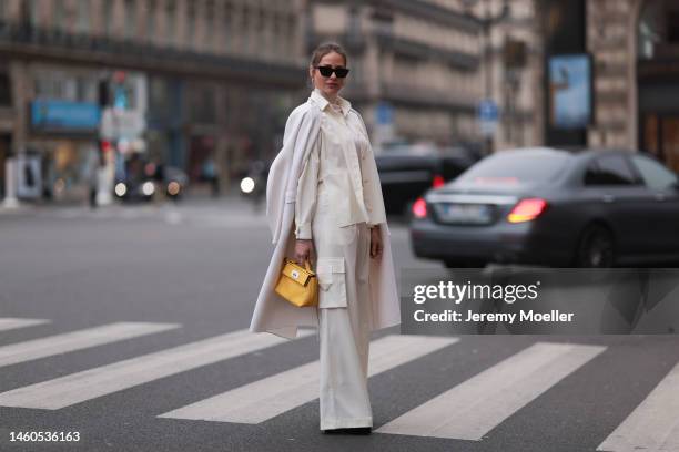 Ginta seen wearing white Bequartii blouse, white Bequartii turtleneck sweater, white long coat Zuhair Murad, white Bequartii trousers, yellow small...