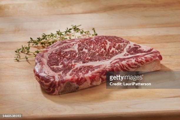 raw rib eye beef steak - strip steak stock pictures, royalty-free photos & images