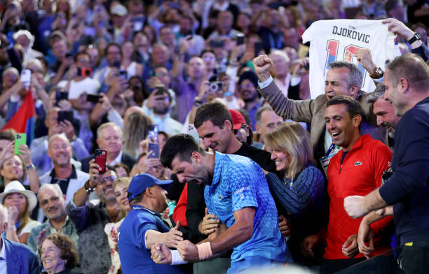 Novak Djokovic of Serbia celebrates in his teams box after winning the Men's Singles Final match against Stefanos Tsitsipas of Greece during day 14...