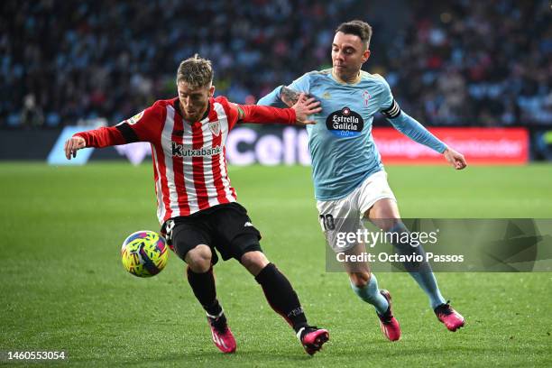 Iker Muniain of Athletic Club is challenged by Iago Aspas of RC Celta during the LaLiga Santander match between RC Celta and Athletic Club at Estadio...