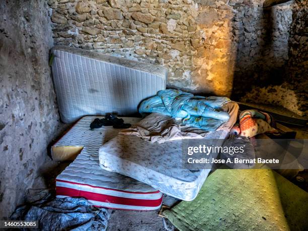 bedroom with mattresses in an abandoned house occupied by illegal immigrants. - creepy shack stock pictures, royalty-free photos & images