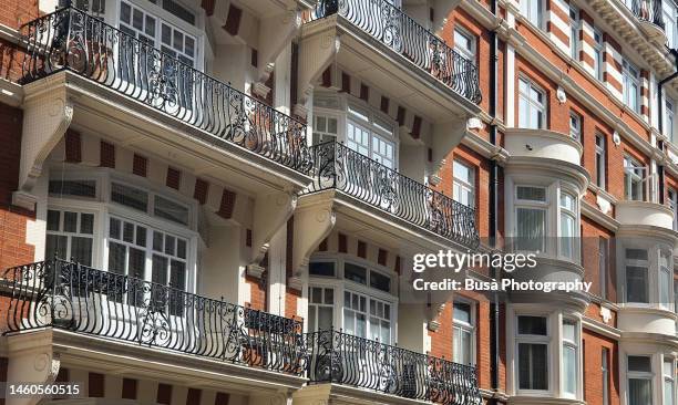 elegant red-brick victorian townhouses and residential buildings in knightsbridge, london - knightsbridge stock pictures, royalty-free photos & images