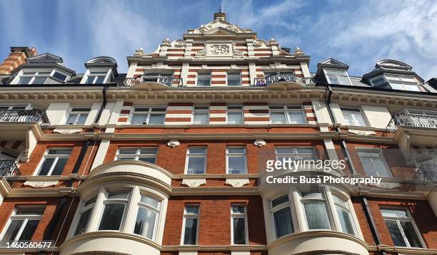 elegant red-brick victorian townhouses and residential buildings in knightsbridge, london - knightsbridge stock pictures, royalty-free photos & images