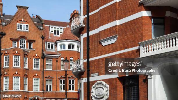 elegant red-brick victorian townhouses and residential buildings in knightsbridge, london - knightsbridge stock pictures, royalty-free photos & images