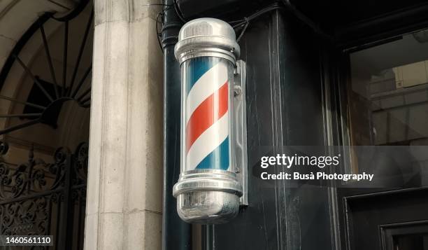 old-fashioned barber's pole in london, england - vintage beauty salon stock pictures, royalty-free photos & images