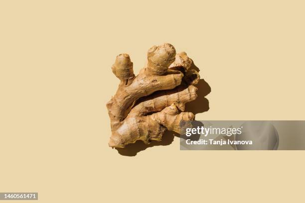 fresh ginger on beige background. flat lay, top view, copy space. - root ginger stock pictures, royalty-free photos & images