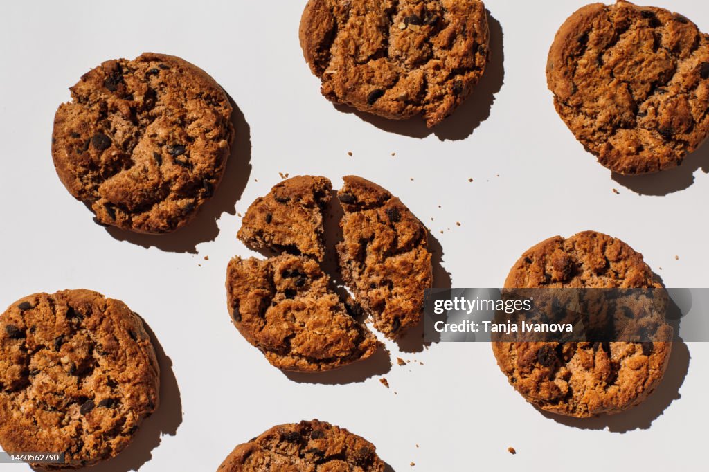 Pattern chocolate chip cookie on white background. Brown baked cookies, filled with chocolate. Flat lay, top view