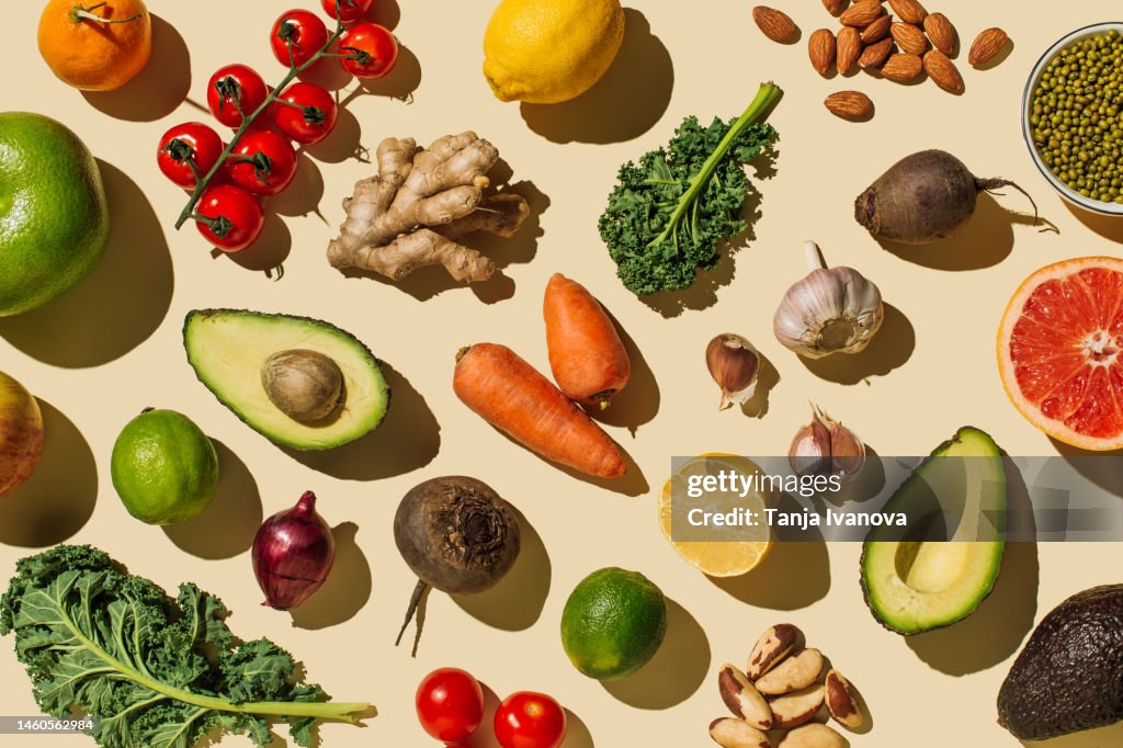 Pattern of variety fresh of organic fruits and vegetables and healthy vegan meal ingredients on beige background. Healthy food, clean eating, diet and detox, eco friendly, no plastic concept . Flat lay, top view
