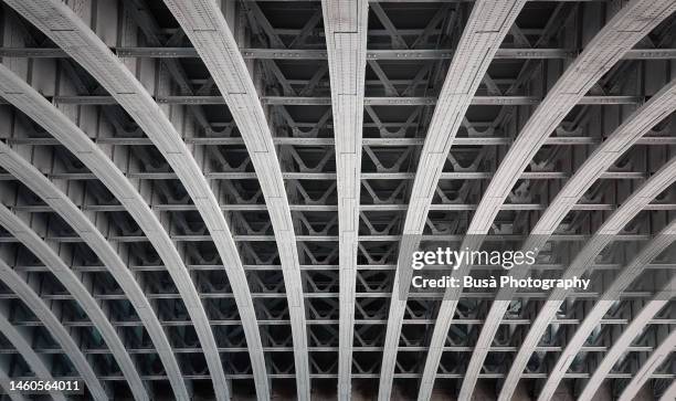 iron beams under bridge deck - holzbalken stock-fotos und bilder