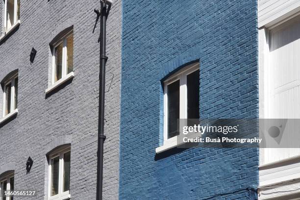 detail of colorful painted brick facade of residential buildings in london, england - painted brick house stock pictures, royalty-free photos & images