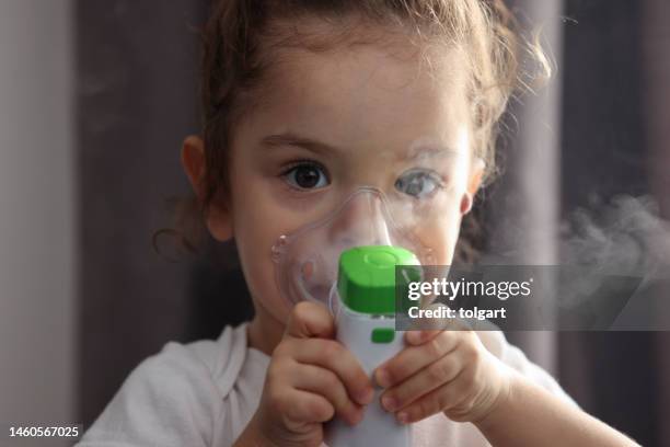 little girl using nebulizer - reliever asthma inhaler stock pictures, royalty-free photos & images