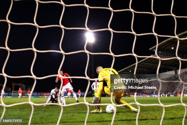 Paul Mullin of Wrexham scores the team's third goal as Adam Davies of Sheffield United attempts to make a save during the Emirates FA Cup Fourth...