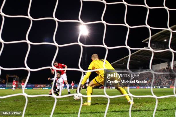 Paul Mullin of Wrexham scores the team's third goal as Adam Davies of Sheffield United attempts to make a save during the Emirates FA Cup Fourth...