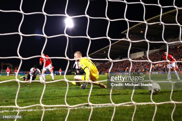 Paul Mullin of Wrexham scores the team's third goal as Adam Davies of Sheffield United attempts to make a save during the Emirates FA Cup Fourth...