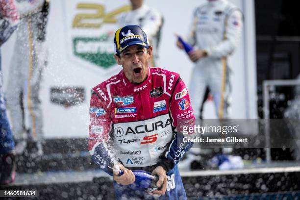 Helio Castroneves driver of The Meyer Shank Racing w/ Curb-Agajanian Acura ARX-06 celebrates in victory lane with teammates Tom Blomqvist, Colin...