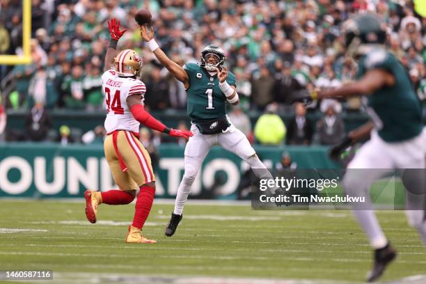 Jalen Hurts of the Philadelphia Eagles throws a pass to DeVonta Smith against Charles Omenihu of the San Francisco 49ers during the first quarter in...