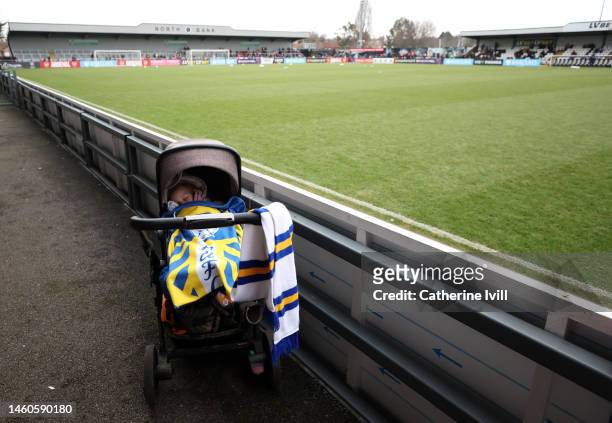 Young fan in a pram at the side of the pitch ahead of the Vitality Women's FA Cup Fourth Round match between Arsenal and Leeds United at Meadow Park...