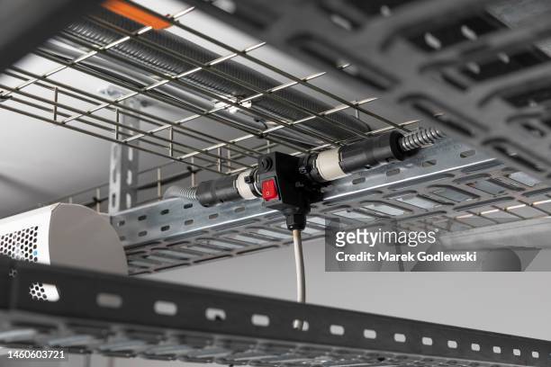 steel cable management baskets and trays with modular wiring, t conduit connector, drum of armored cable, electrical installation - home run stock pictures, royalty-free photos & images