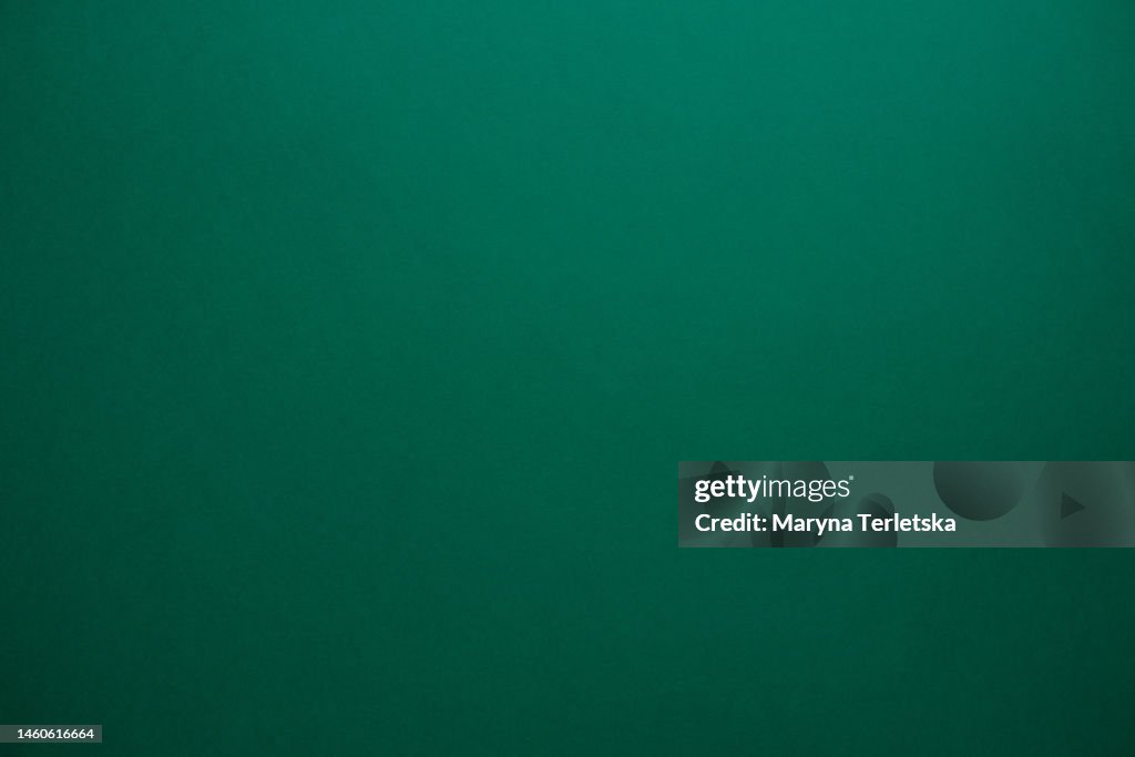 Universal colored background. Background for text and pictures. Paper base. Copy space. Dark green background.