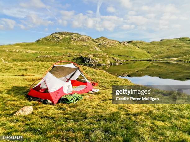 tent pitched by angle tarn in the english lake district - valley side stock pictures, royalty-free photos & images