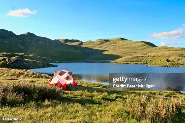 tent pitched by angle tarn in the english lake district - valley side stock pictures, royalty-free photos & images