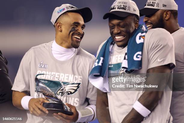 Jalen Hurts of the Philadelphia Eagles holds the George Halas Trophy with A.J. Brown after defeating the San Francisco 49ers to win the NFC...