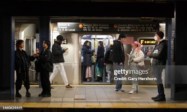 People board an F-line subway train at the Broadway-Lafayette Street station on January 28 in New York City.