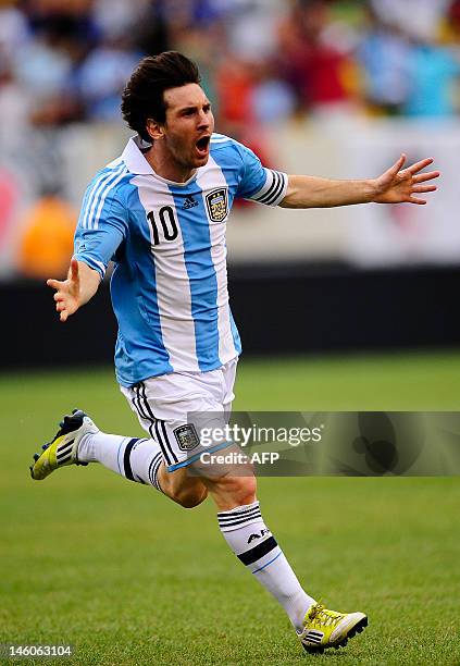 Argentinian soccer player Lionel Messi celebrates after scoring his third goal during a friendly match against Brazil at the MetLife Stadium in East...