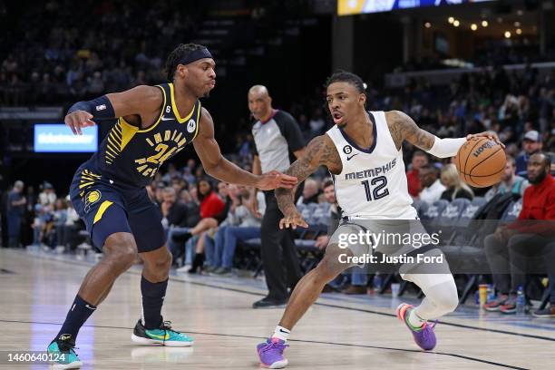 Ja Morant of the Memphis Grizzlies handles the ball during the second half against Buddy Hield of the Indiana Pacers at FedExForum on January 29,...