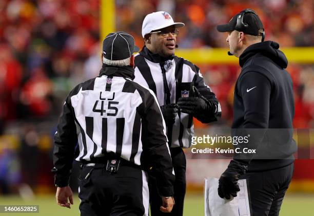 Head coach Zac Taylor of the Cincinnati Bengals talks with referee Ronald Torbert and line judge Jeff Seeman during the second half against the...