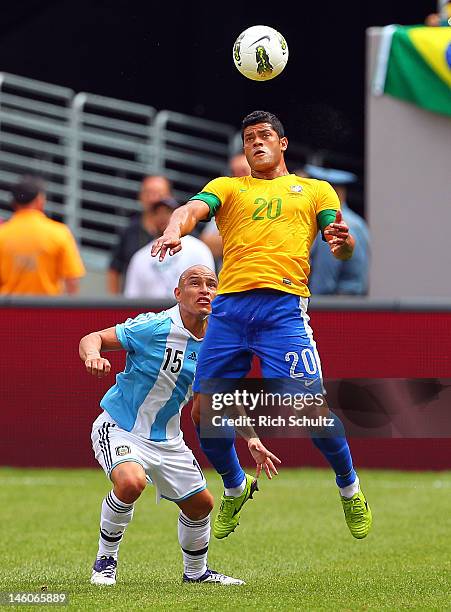 Hulk of Brazil heads the ball in front of Clemente Rodriguez of Argentina during the second half of an international friendly soccer match on June 9,...