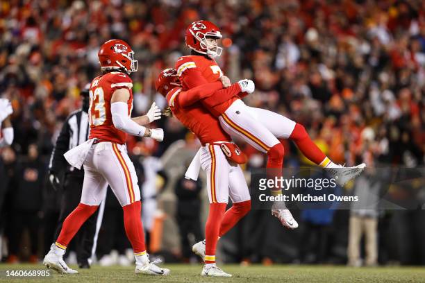 Tommy Townsend of the Kansas City Chiefs lifts Harrison Butker of the Kansas City Chiefs in celebration after Butker kicked the game winning field...