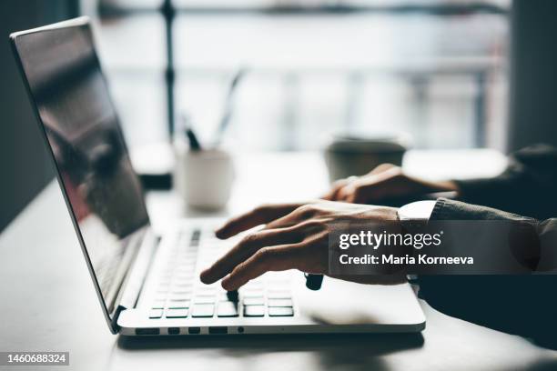 man working online at home on his laptop computer. - redakteur stock-fotos und bilder