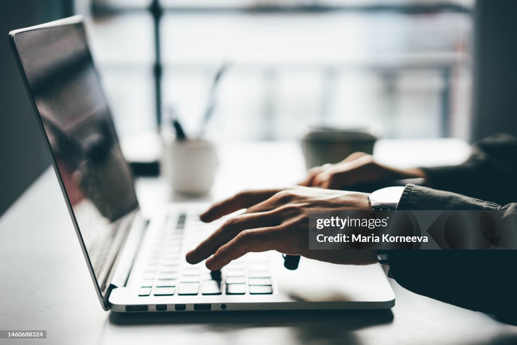 Man working online at home on his laptop computer.
