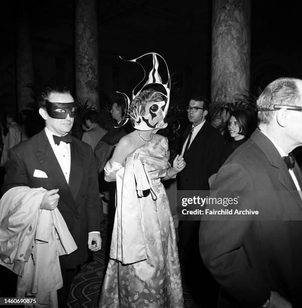 Couple in masks arriving at Truman Capote's Black and White Ball in the Grand Ballroom at the Plaza Hotel in New York City