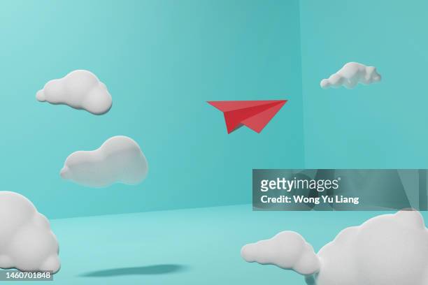 red paper plane in clouds ,3d render concept photo - idol ストックフォトと画像