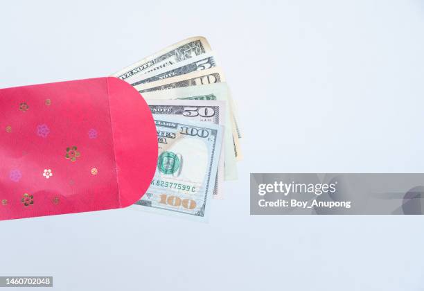 close up of american dollar banknotes in a red envelope. - chinese new year red envelope stock pictures, royalty-free photos & images