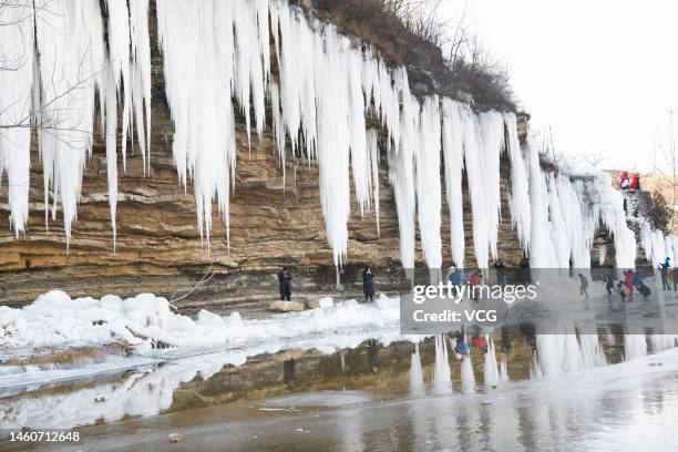 People enjoy icefall scenery at shanting district on January 29, 2023 in Zaozhuang, Shandong Province of China.