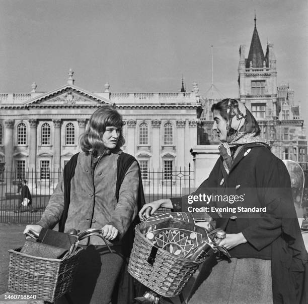 Two Cambridge University students named as Jane Featherstone Lee and Sally Richmond pictured with their bicycles, circa November 10th, 1959.