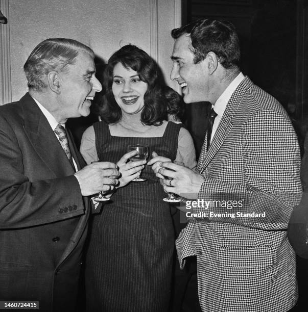 British actor and writer Emlyn Williams , actress Caroline Mortimer and playwright Harold Pinter attending an event on February 16th, 1961.