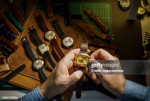 watch collector is adjusting the mechanical watch in his workshop - coleção imagens e fotografias de stock