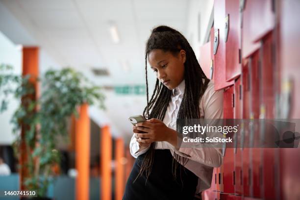 worried at school - girl using phone stock pictures, royalty-free photos & images