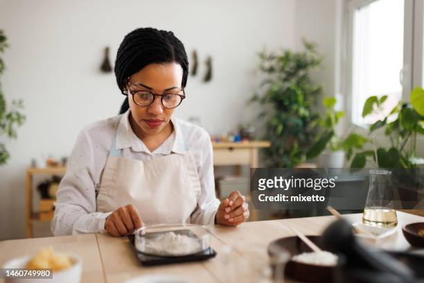 woman making skin care products with zeolite powder - ph balance stock pictures, royalty-free photos & images