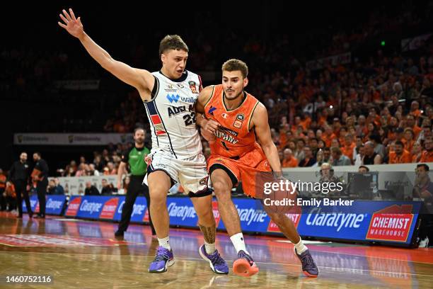 Hogg of the Taipans drives up court under pressure from Hyrum Harris of the 36ers during the round 17 NBL match between Cairns Taipans and Adelaide...