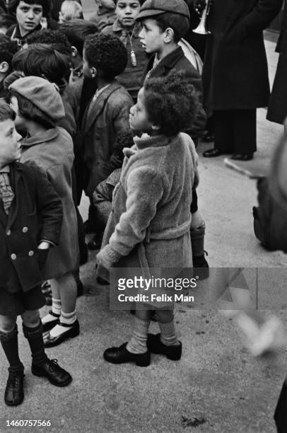 Group of children on the street listen to the Salvation Army band in Tiger Bay, Cardiff. Original Publication: Picture Post - 104 - Cardiff - pub....