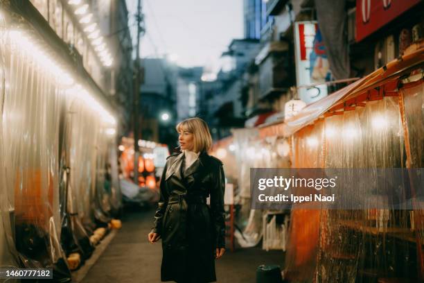 woman in tokyo backstreet at night in winter - tokyo japan night alley stock pictures, royalty-free photos & images