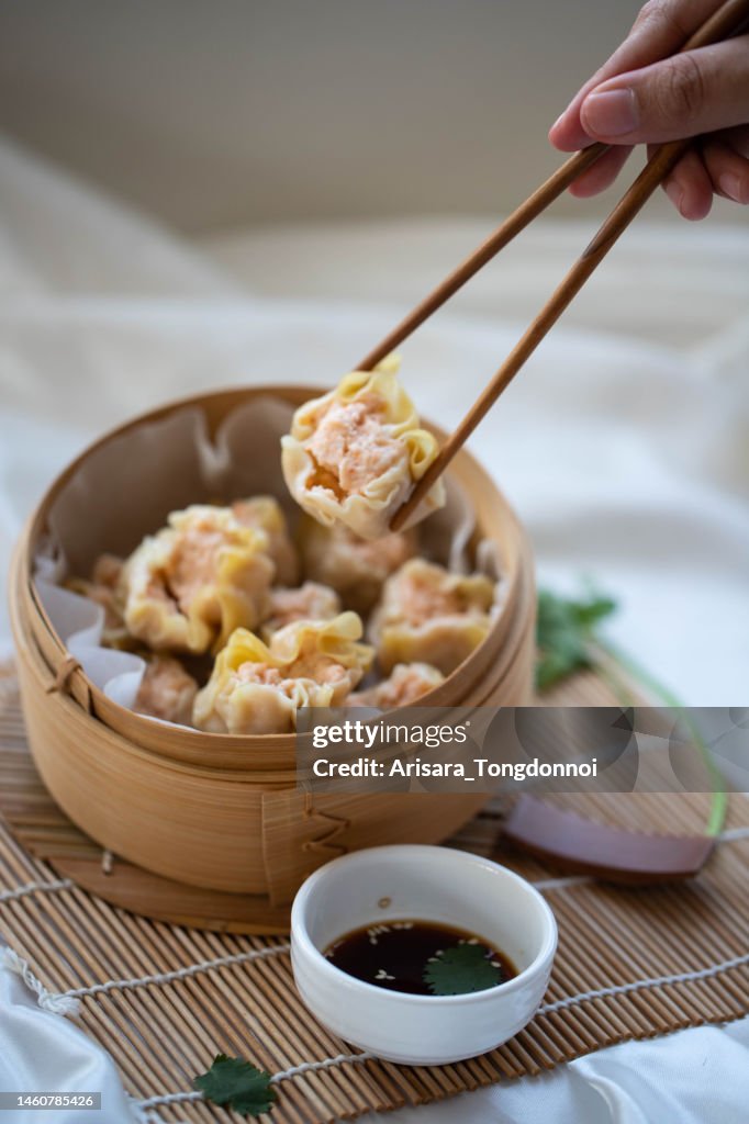 Dumpling Hand Hand Taking Chinese Dumpling With Wooden Chopsticks High-Res Stock ...