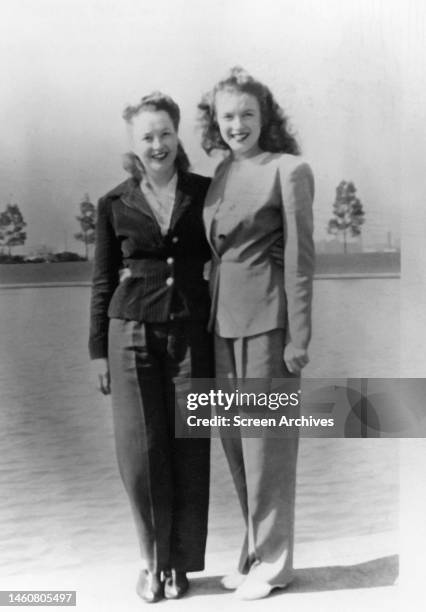Young teenage Norma Jeane Baker, who would later go on to become the legendary film star Marilyn Monroe, posing with her half sister Berniece Baker...