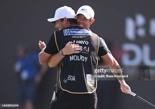 Rory McIlroy of Northern Ireland celebrates victory with their caddie, Harry Diamond on the 18th green in the Final Round on Day Five of the Hero...