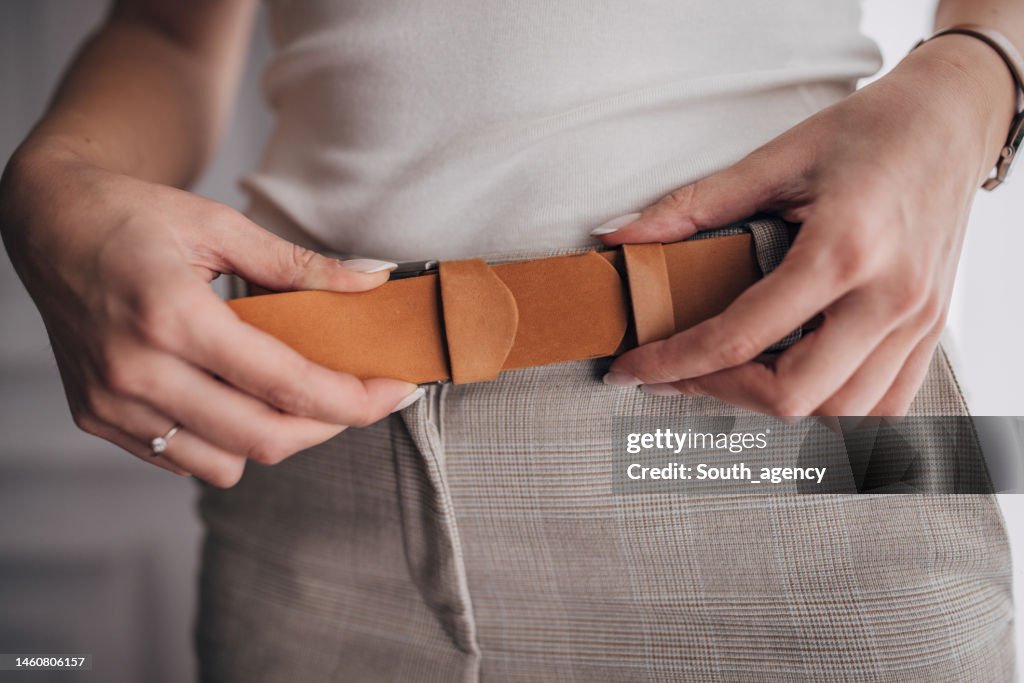 Woman wearing modern leather belt